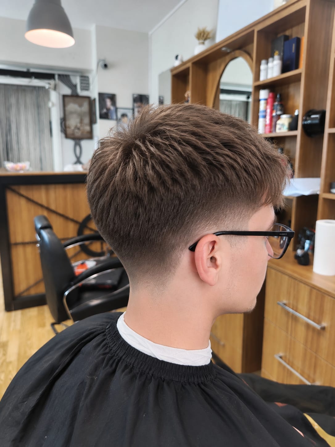 Barber shaping a full beard with scissors